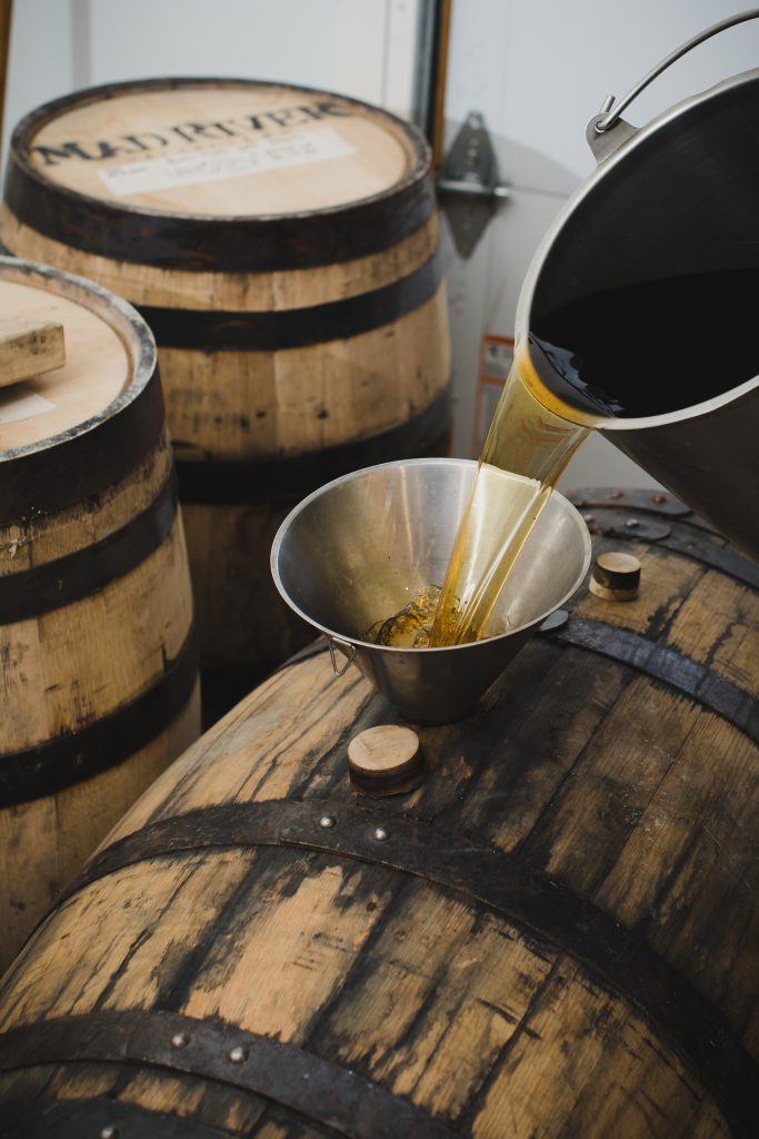 Craft Rum, American Rum being funneled into a barrel at Mad River Distillers