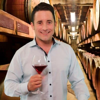 headshot-evan@2x Portrait of Evan with wine glass