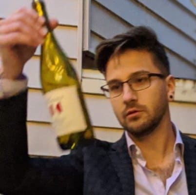 headshot-stefan@2x Portrait of Stefan with wine bottle