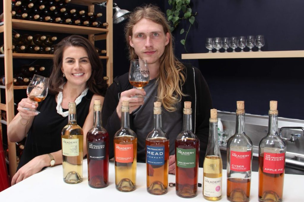 Suzanne and John of The Meadery posing with their lineup of bottles