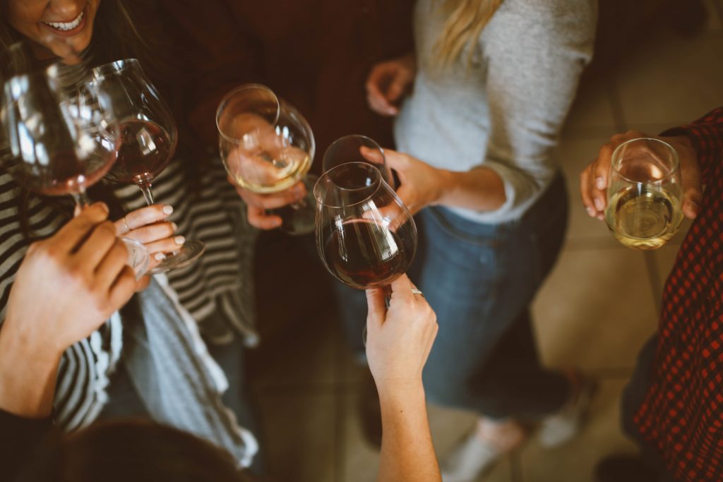 Group of people toasting wine glasses at team building event