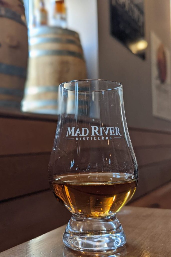 A tasting at Mad River Distillers Mad River Distillers tasting glass filled with one of their aged spirits in their Burlington tasting room.