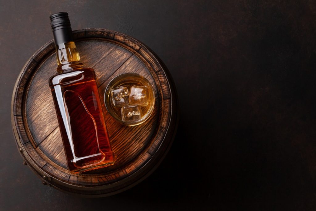 bourbon bottle on a barrel