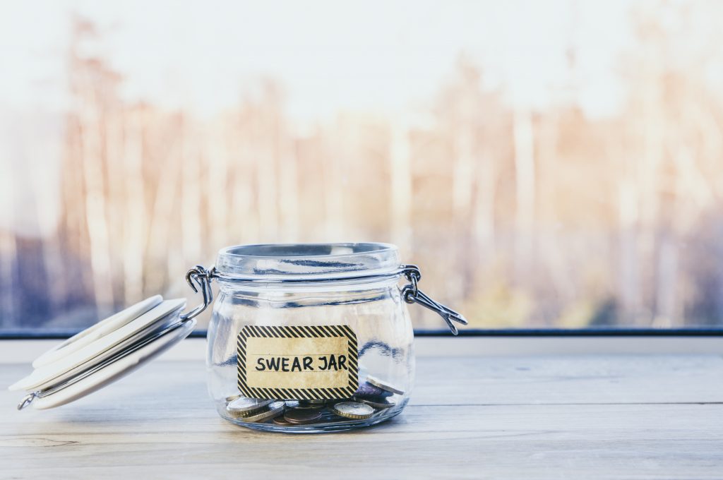 Swear jar with coins in it