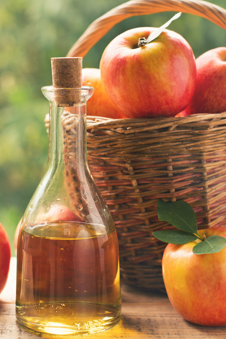 Basket of Apples with a Carafe of Apple Cider cider apples in a basket with a carafe of apple cider in front