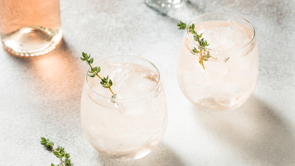 white wine spritzers with a sprig of thyme